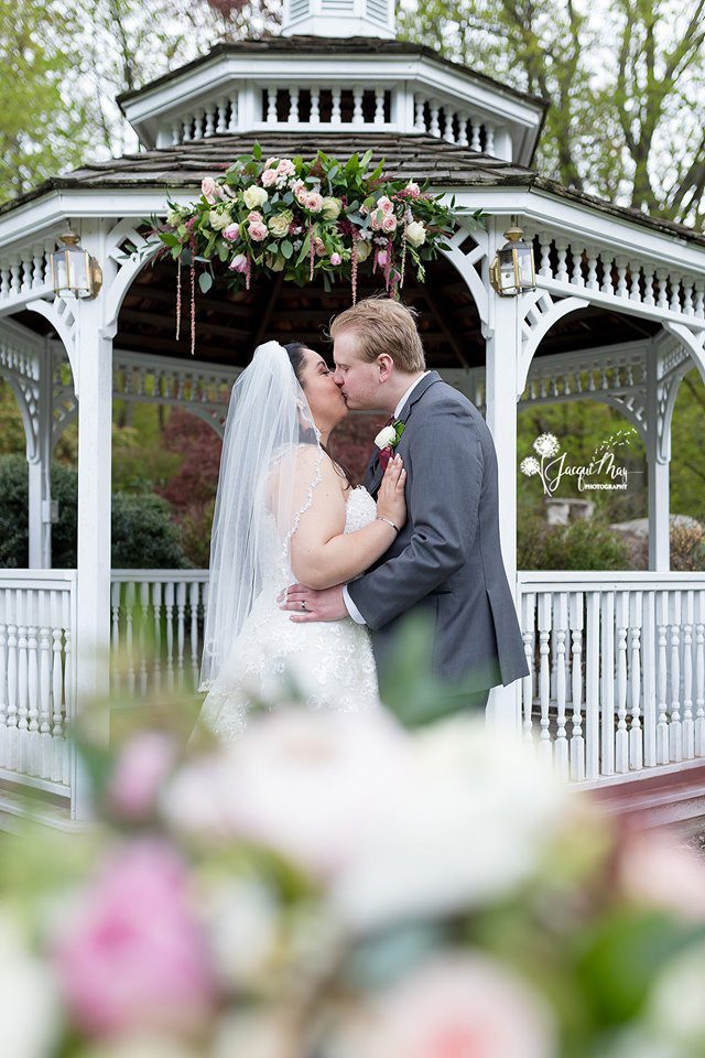 Gazebo Wedding Ceremony may-wedding-couple-kissing-in-front-of-gazebo